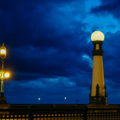 Streetlights on a bridge at dawn in San Sebastian.